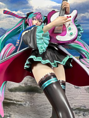 OSAKA,JAPAN - JULY 10, 2023 : Studio shot of a statue of Miku Hatsune strumming an electric guitar at a live performance of the 