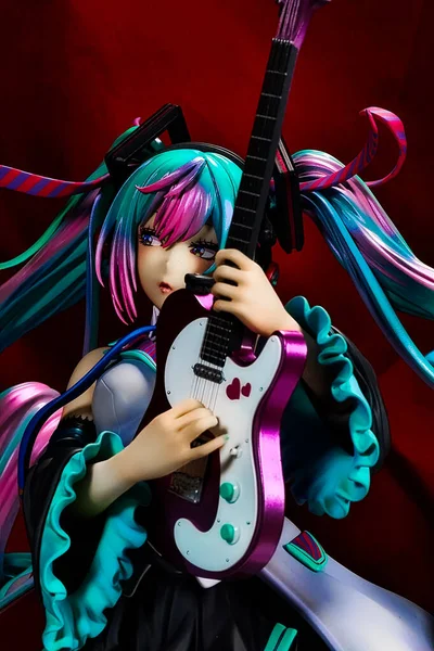 stock image OSAKA,JAPAN - JULY 17, 2023 : Studio shot of a statue of Miku Hatsune strumming an electric guitar at a live performance of the 