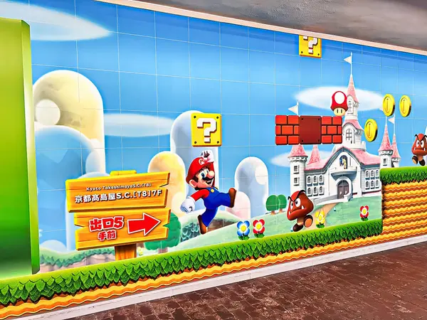 stock image KYOTO,JAPAN - MAY 24, 2024 : New and old versions of the Mario Brothers mural in the Takashimaya department store in Kyoto.