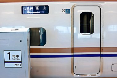 TSURUGA, JAPAN - MAR 5, 2024: The HOKURIKU Shinkansen Kurşun Treni (W7 Type) JR TSURUGA istasyonundaki platforma yaklaşır. Hokuriku Sinkansen Mart 2024 'te açılan yüksek hızlı bir demiryolu hattıdır..