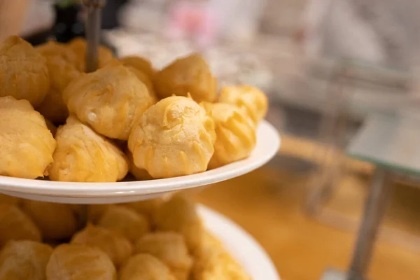 Close up of eclair or cream puffs in buffet at the party