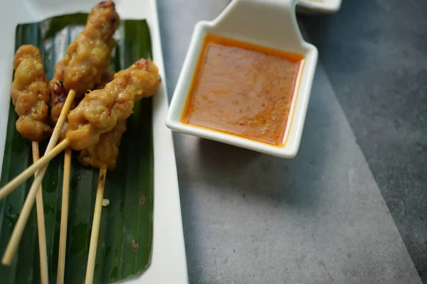Pork satay, Thai food. A type of food satay use meats pork cut into thin slices, marinated with seasonings, and then grilled on a skewer. Eat with peanut sauce