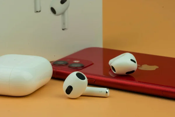 stock image Bangkok, Thailand - December 24, 2022 : New AirPods 3 third generation. Headphones from the apple company with iPhone 11.
