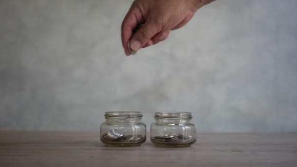 Close Shot Drop Coins Glass Jar Saving Money Multiple Purposes — Vídeo de stock