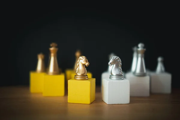 Golden and silver horse chess pieces Invite face to face and There are chess pieces in the background. Concept of competing, leadership and business vision for a win in business games