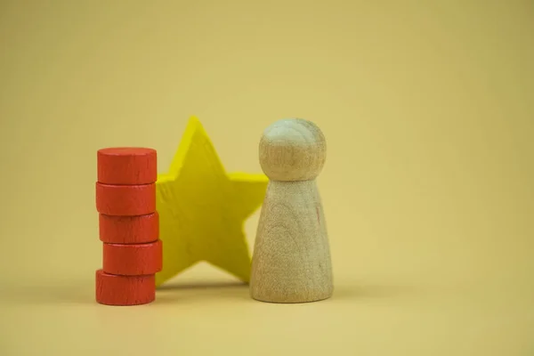Wooden figures peg doll standing 1st positions with wooden cube blocks star. ranking and strategy concept.