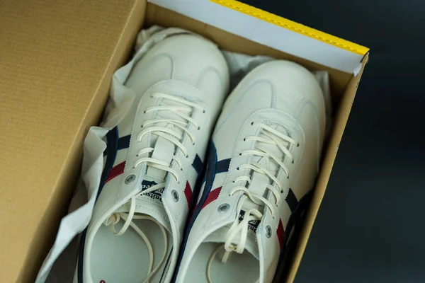 stock image Bangkok, Thailand - March 4, 2023 : The shoes made by Onitsuka Tiger popular hit in the box. Top view