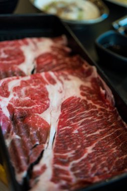 Close up shot of sliced marble wagyu meat for shabu shabu hot pot