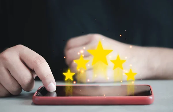 Customers give a five star rating feedback on smartphones. Review, and satisfaction with the products and services increase the credibility. The concept of service reviews from customers.