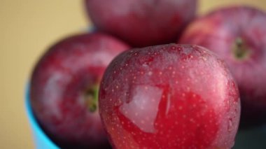 Cildinde su olan kırmızı elma. Yaklaş ve dön.