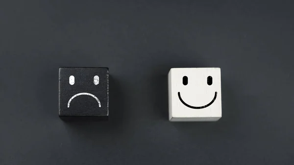 Smile and angry emotion face block for choosing emoticon for user reviews on a black background. Service rating, mental health, positive thinking, satisfaction, evaluation and feedback concept
