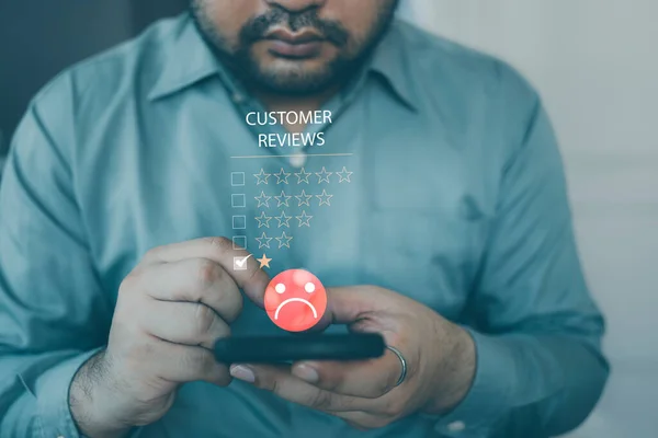 Customer experience dissatisfied Concept, Unhappy businessman client with sad emotion face on smartphone screen. Bad review, bad service dislikes bad quality, low rating, social media not good.