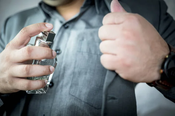 stock image Handsome man in suit using perfume. Close up