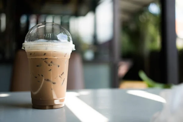 Refreshing iced Mocha coffee on table in a garden cafe on a beautiful summer day. Refreshing drink in a garden cafe.