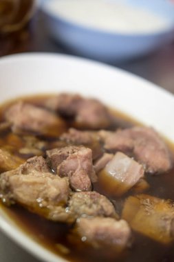 Tayland 'da pilav ya da erişteyle yenen beyaz bir kasede pişmiş domuz eti. Kapat.