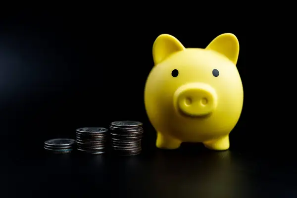 Yellow piggy bank with stack coins with growth of value, Saving money for investment and spending. Planning saving strategy for future plan of wealth, travel, education, investment and retirement.