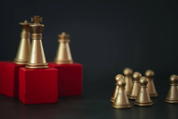 King gold chess on top with gold pawn on under for business metaphor leadership concept. Strategy game as business challenge competitive game