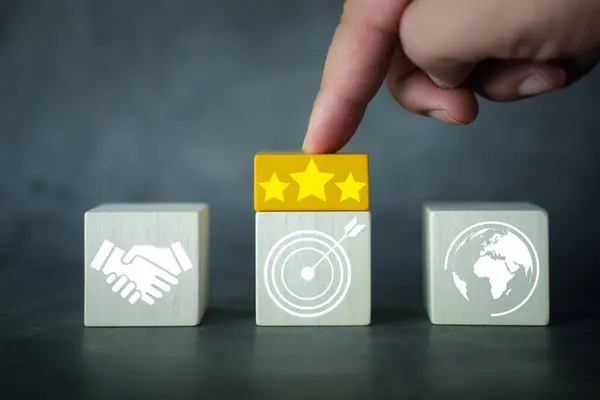 Set goals for success three stars, use yellow wooden blocks to create ideas, and set targets. Business goals and marketing strategies. Company development. Wooden cubes with business strategy icons