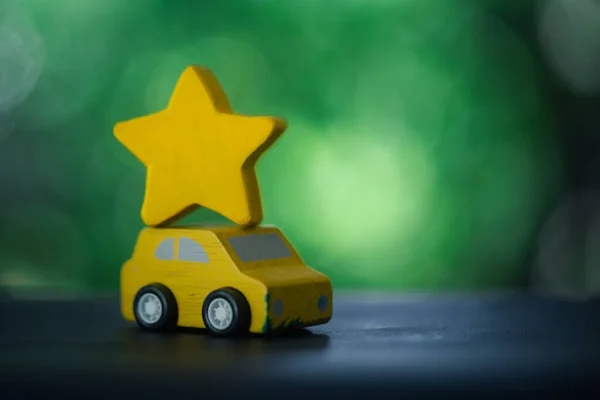 Yellow car with a yellow star on top. The concept of choose the best car