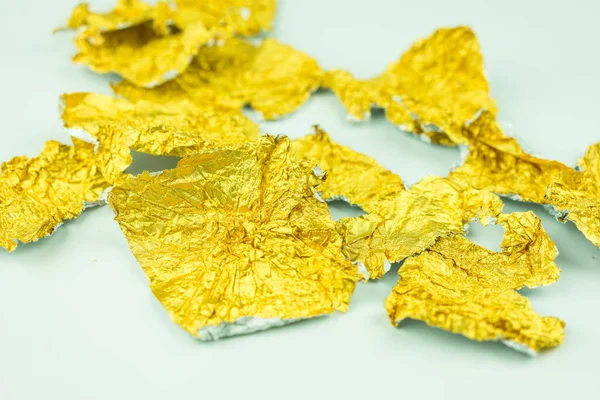 Candy golden wrapper is empty and open. Gold foil after eat candy