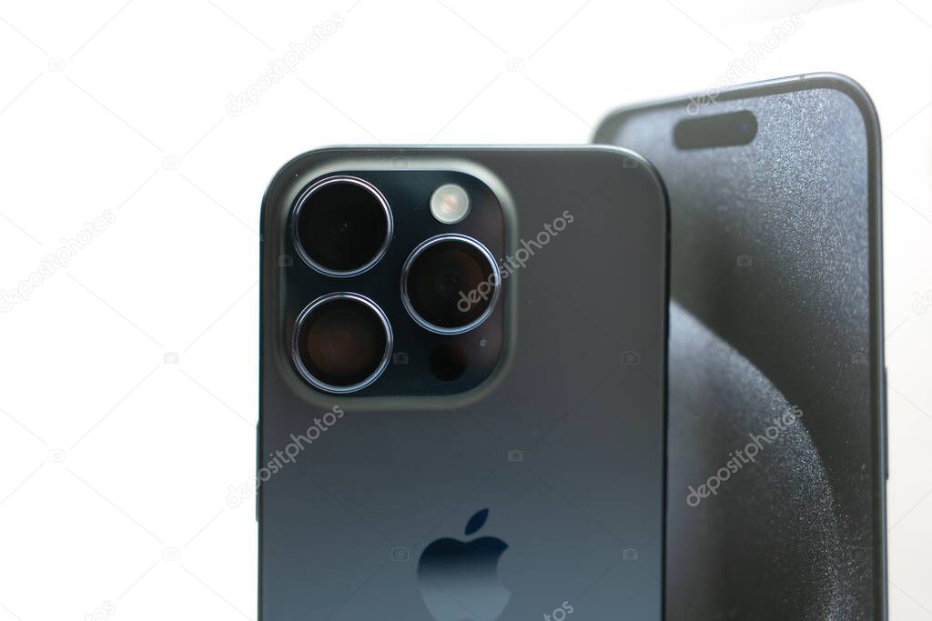 Bangkok, Thailand - October 23, 2023 : Back section of the new Apple a Titanium Blu iPhone 15 Pro, with focus on the three lenses.