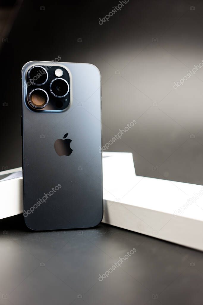 Bangkok, Thailand - October 29, 2023: The new iPhone 15 Pro Titanium Blue with best triple camera on a black background