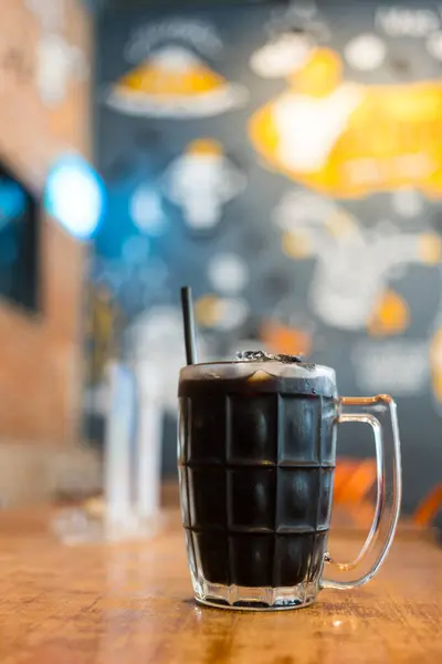 Thai iced black coffee signature local beverage on wooden background called oliang