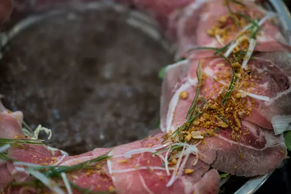 stock image Thin pork for poached Thai soup with braised beef or pork, meatball, and vegetable in fire hot pot, that is popular in Thailand is called Boat Noodle Hot Pot.