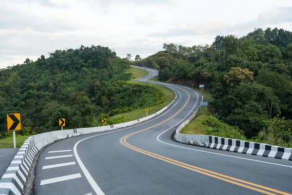 Beautiful curved road look like number 3 on the high mountain in Nan province, Thailand. An iconic tourist attraction place on the way to Bo Kluea district, Nan, Thailand.