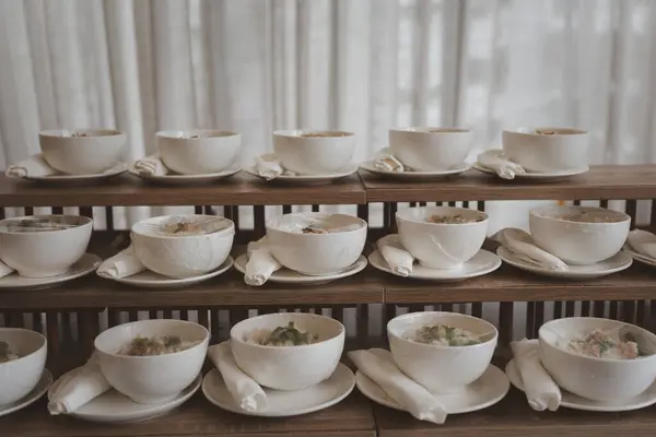 Boiled rice soup in a white bowl prepared for guests in the wedding ceremony, appetizer food