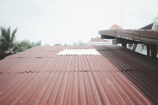 Thai house with rusted zinc roof. Zinc roof old grunge