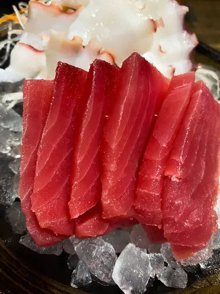 Fresh tuna raw sashimi on ice. Top view