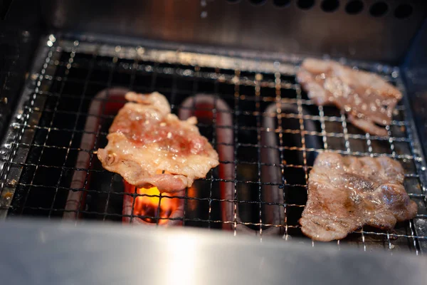 Yakiniku Japanese grilled beef on electric grill. Close up
