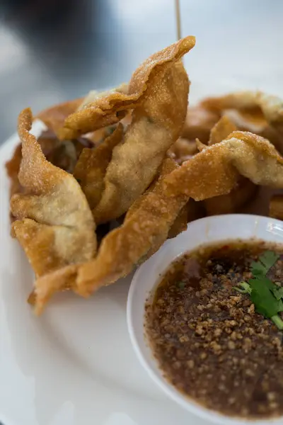 Thai fried dumplings or deep fried wonton served with dipping sweet nut sauce