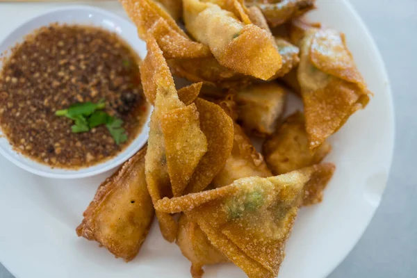 Thai fried dumplings or deep fried wonton served with dipping sweet nut sauce
