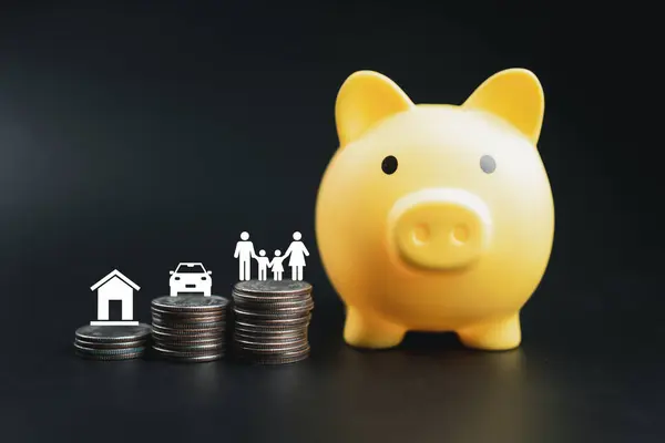 Yellow piggy bank and coins stacked like a graph with house icon, car icon and family icon on coins stack. Saving ideas and investment budget, Business saving money concept, Copy space