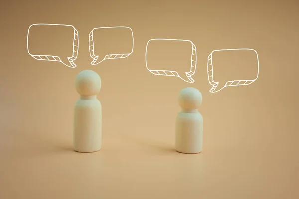 Wood peg doll with pop up of empty speech bubbles. A speech bubble indicating conversation in life