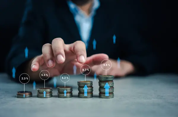 Stacking coins different heights with percentages for interest rates from different investment. Interest rates continue to increase, stock market volatility, taking high investment fund management