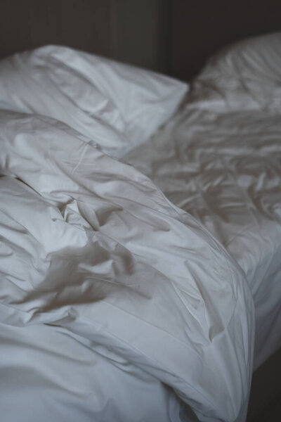 Bedding sheets and pillow. Morning empty messy bed