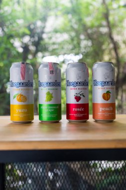 Samut Prakan, Tayland - 5 Temmuz 2024: Meşhur bir Hoegaarden birası Yuzu, Shine muscat üzümü, Rosee ve ahşap masaya konmuş şeftali. Tayland 'da popüler bir ithal bira.