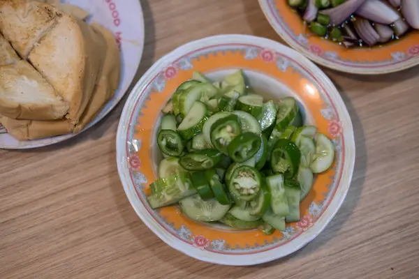 stock image Ajad, or a side dish to eat with pork stew, is made from sliced cucumbers. Sugar simmered with vinegar Add chopped bell pepper and onion.