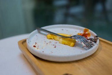 Yemekten sonra pasta lekesi ve meyve lekesi, kirli tabak, arta kalan yemek. Kapat.