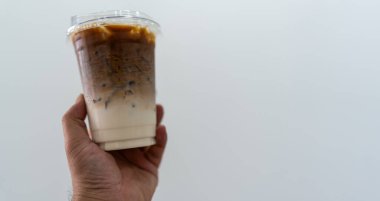 Birisi elinde plastik bir bardak buzlu latte ile metin için fotokopi alanı tutsun..