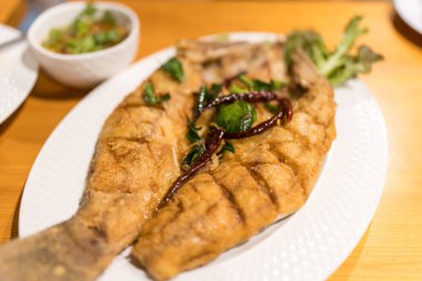 Balık soslu kızarmış levrek. Kapat.