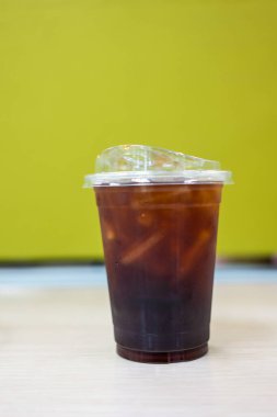 Plastik bardaktaki buzlu kahveyi kapat.