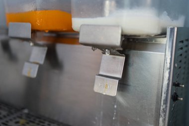 Kahvaltı sırasında yemek odasında portakal suyu ve taze süt büfesi kahvaltısı. Süt dağıtıcısına odaklanmış