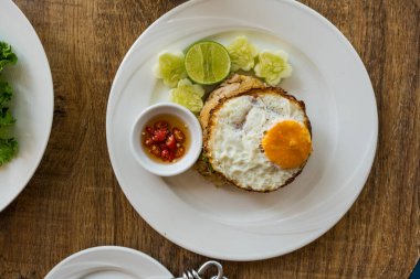 Tayland yemeği, Khao pad moo pilavı, yanında balık sosu, salatalık, limon ve kızarmış yumurta, enfes bir sunum.
