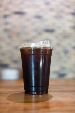 Kahve dükkanında kapağı olan plastik bir fincanda buzlu buzlu kahve..