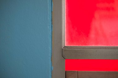 Mavi beton duvarlı ahşap pencerenin detayları. Kapat.