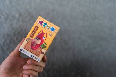Bangkok, Thailand - June 24, 2025 : 52Toys crayon shinchan food ingredients series blind box on man hand